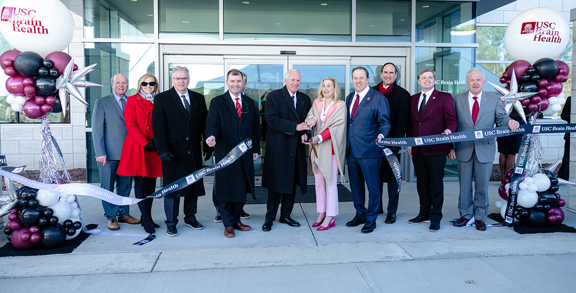 Image of people at a ribbon cutting ceremony at the USC Brain Health Center