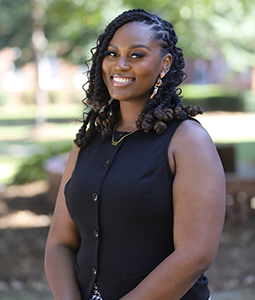 Headshot of Aliyah Little outdoors.