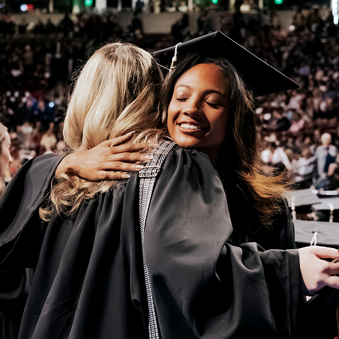 Two women embrace at USC Commencement.