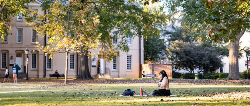 student studying outdoors on campus