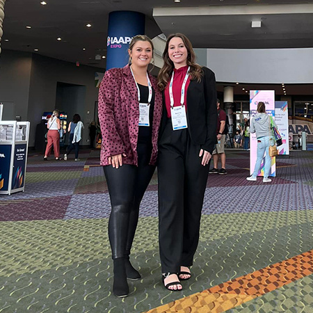 Two students pose for a photo at the IAAPA Expo conference in Orlando.