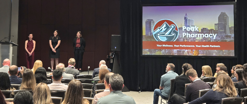 Students on stage with projector screen