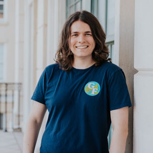 Person leaning against an exterior wall. 