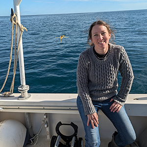 Woman on boat in the ocean with sensor visible in water behind her