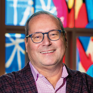 Todd Herman smiles for the camera in the lobby of the Mint Museum in Charlotte, NC